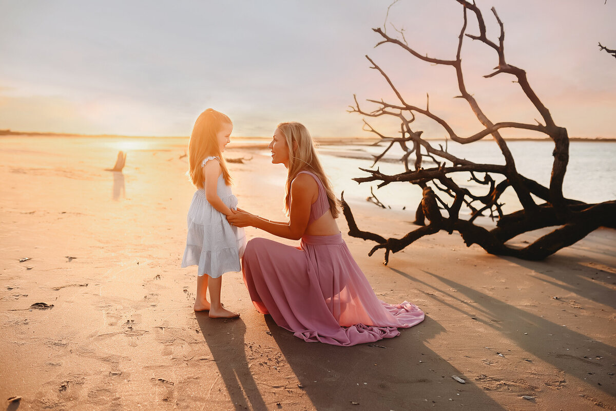 Mother plays with her daughter during Family Photos on Folly Beach.