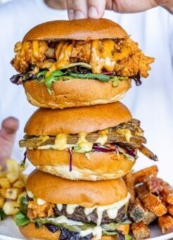 Burgers stacked with delicious fillings for catering with a side of chips