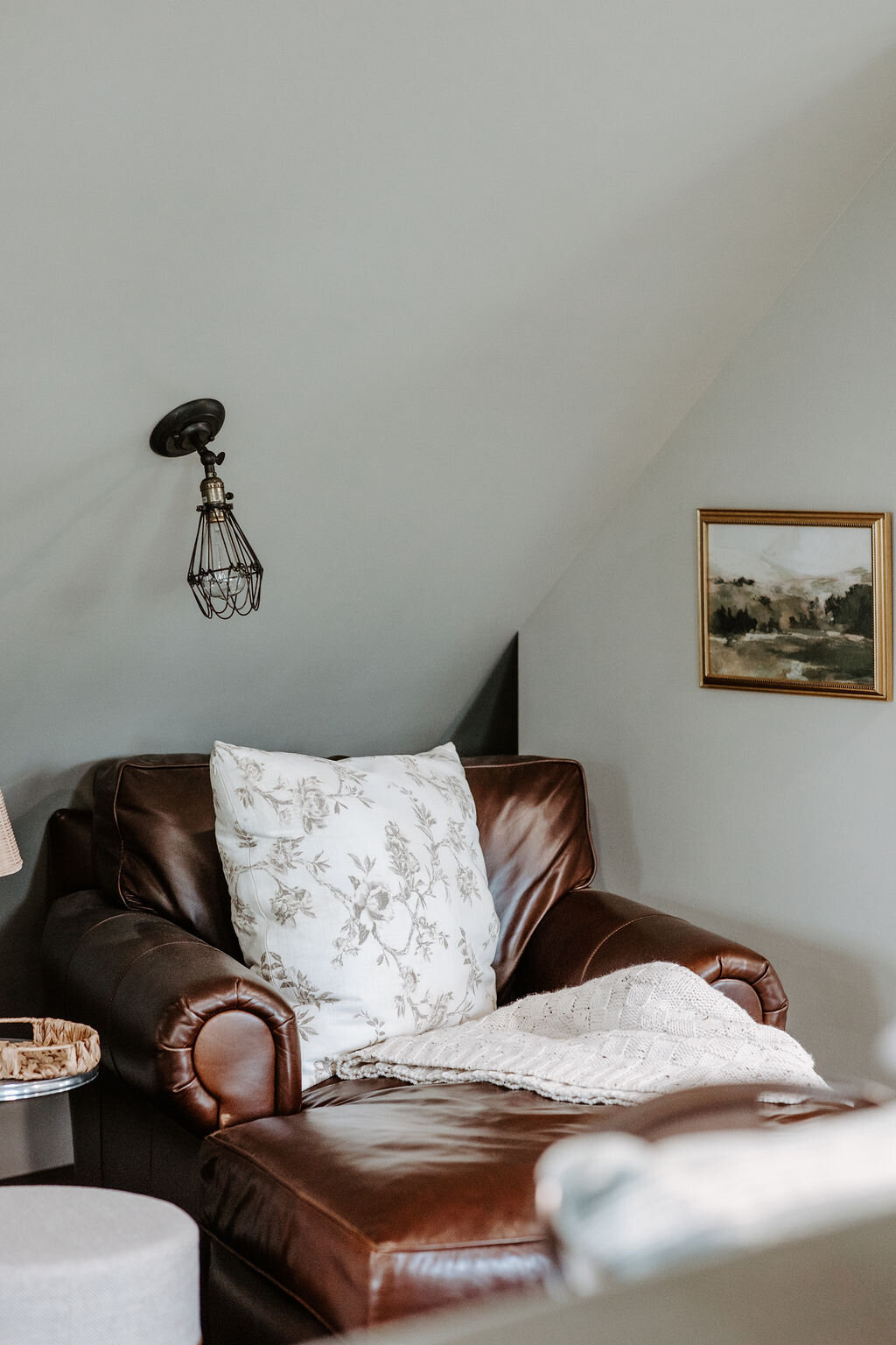 leather restoration hardware chaise with neutral decor in the Willowbrook wedding venue second story overnight studio suite