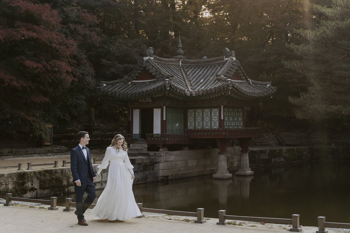 the couple walking while holding hands outside of the secret garden in seoul