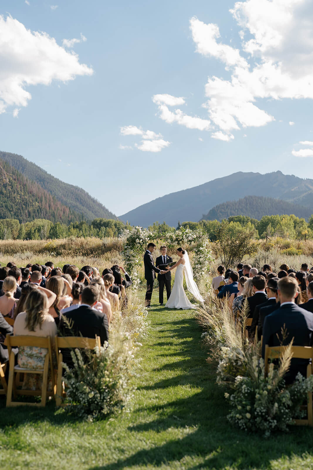 Wide shot view of the wedding ceremony aisle at the Aspen Meadows Resort outdoor Colorado wedding venue.