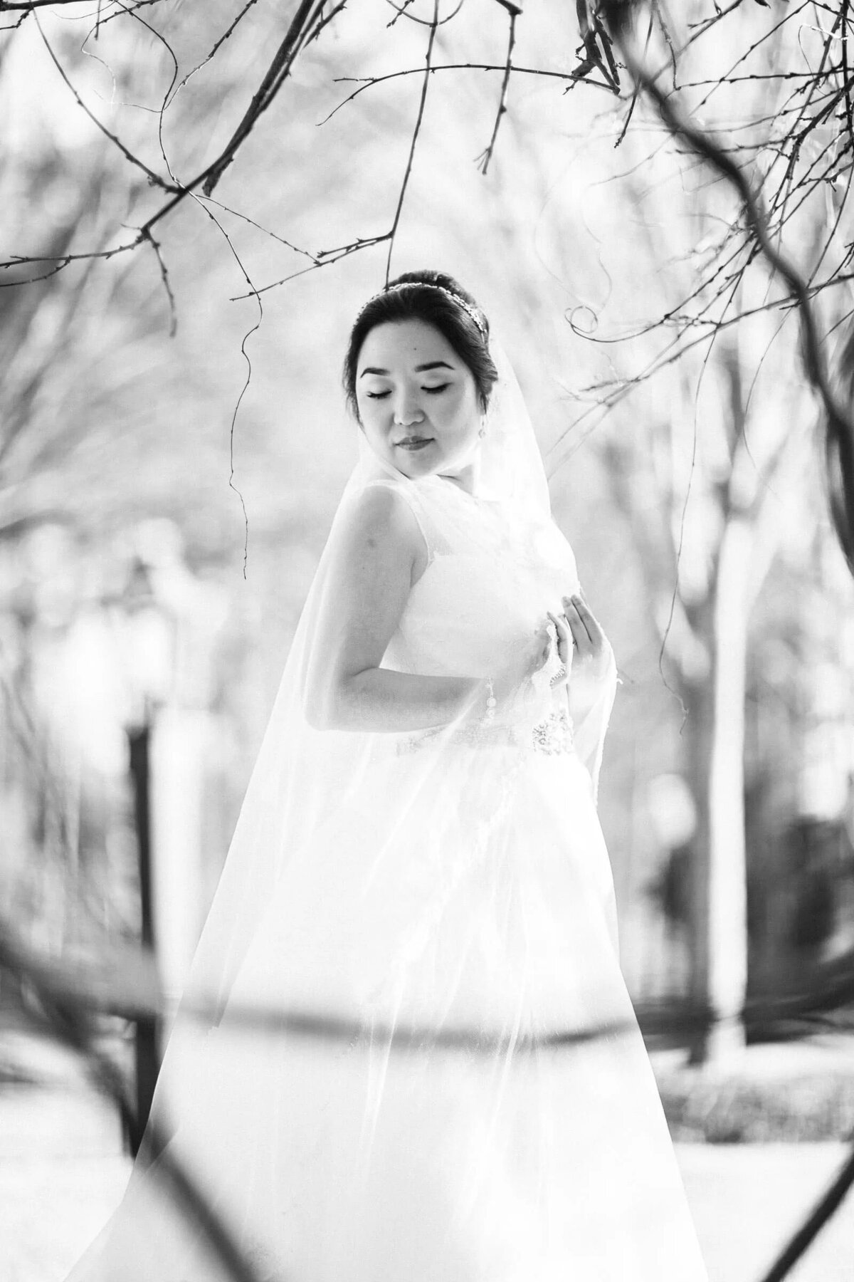 A bride standing in a wooded area