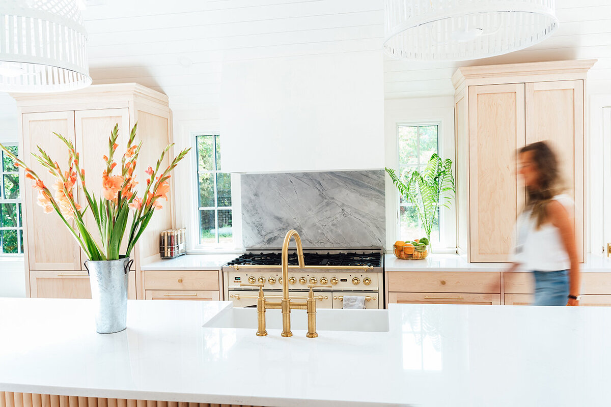 girl walking through a beautiful kitchen blur