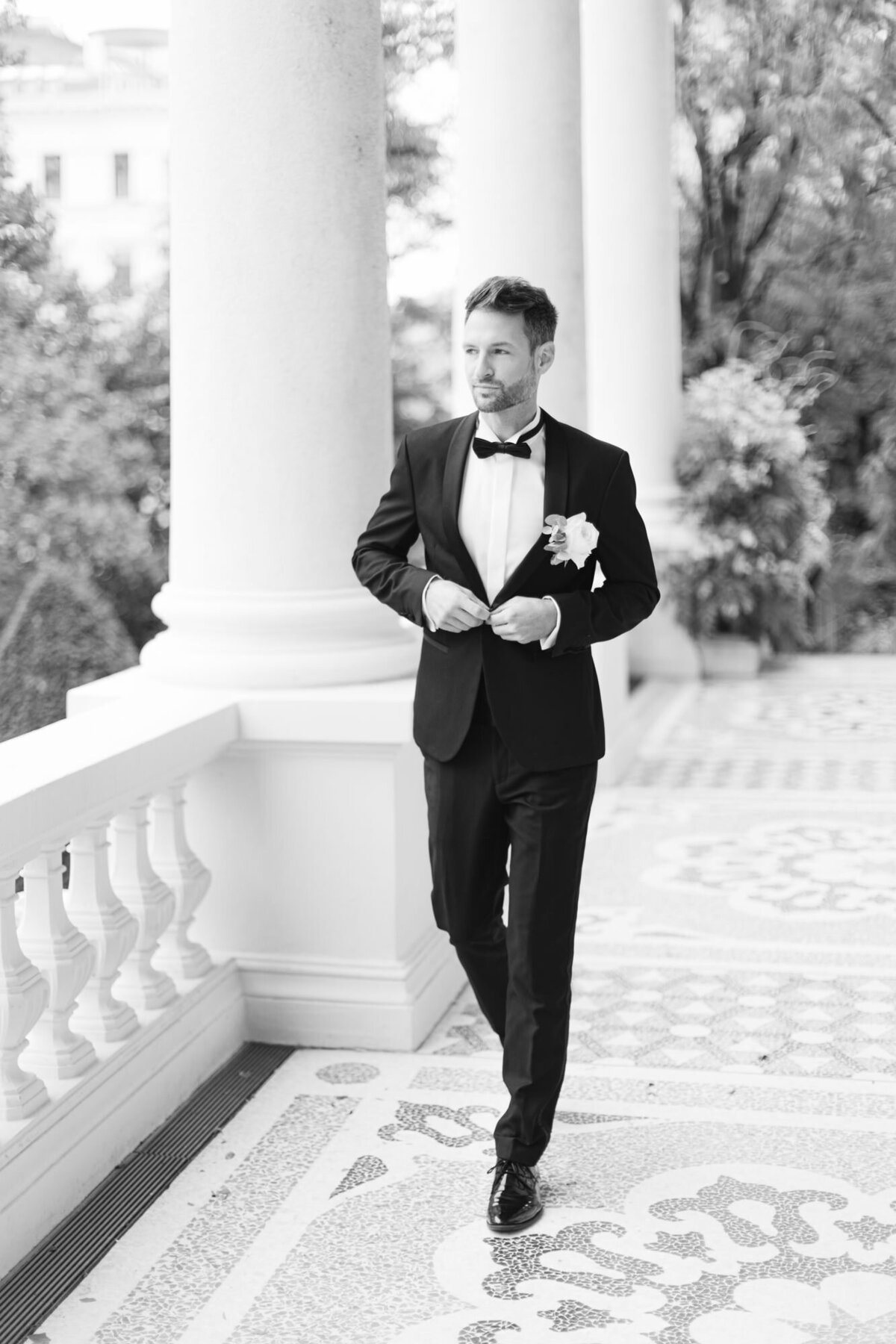 Groom walking on the terrace at wedding palace Coburg meeting the wedding guests