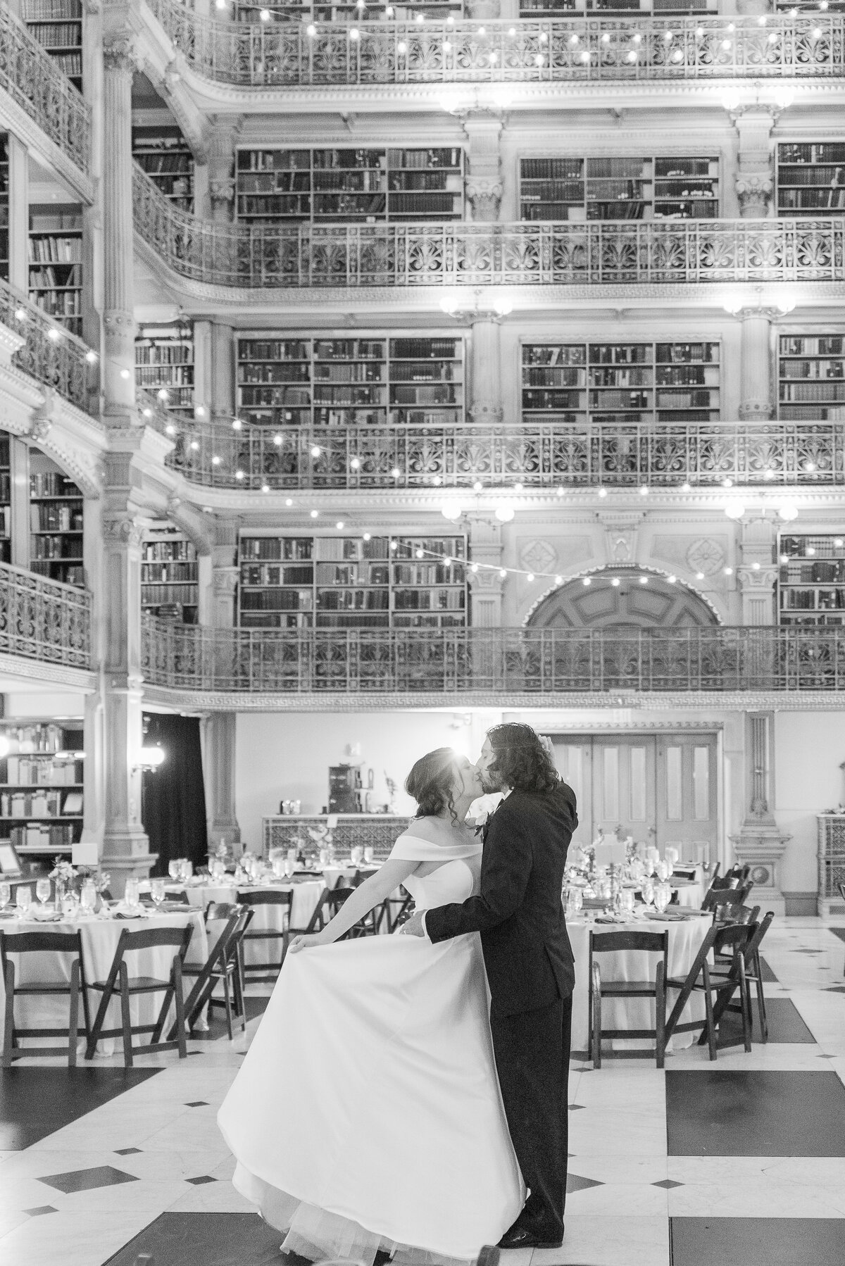 couple kissing and embracing at george peabody library in baltimore