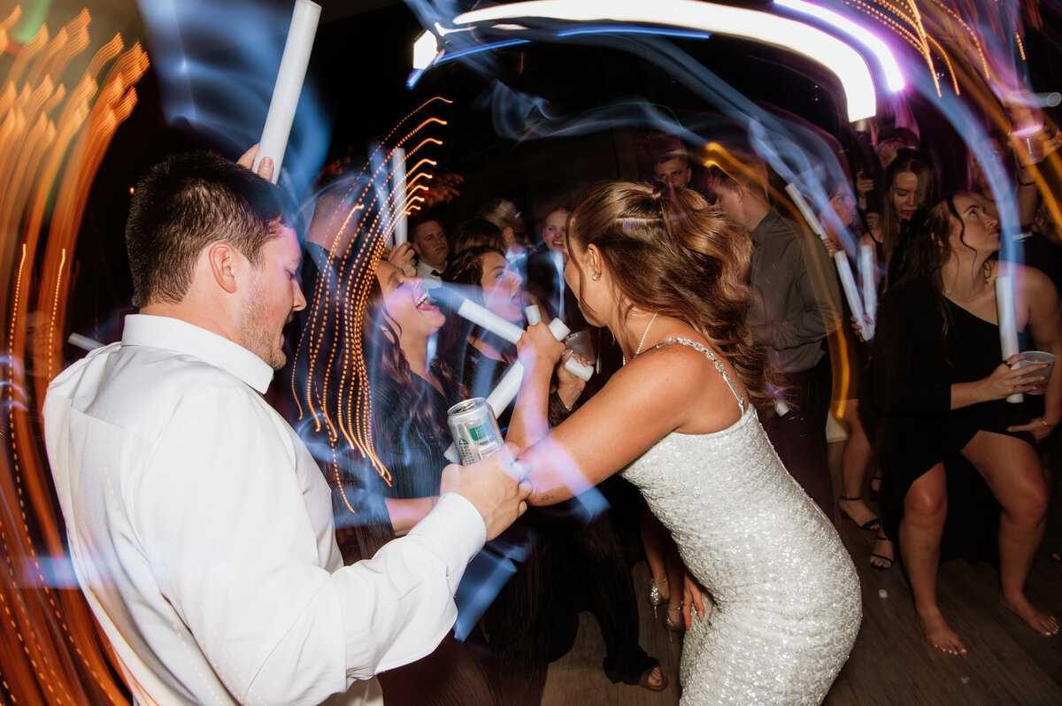 Bride and groom exiting wedding reception with sparklers