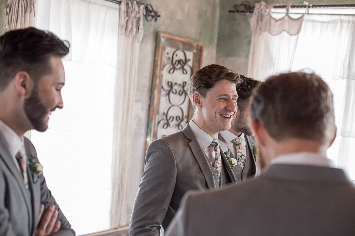 The groomsmen, dressed for the wedding, goof off  before the wedding ceremony