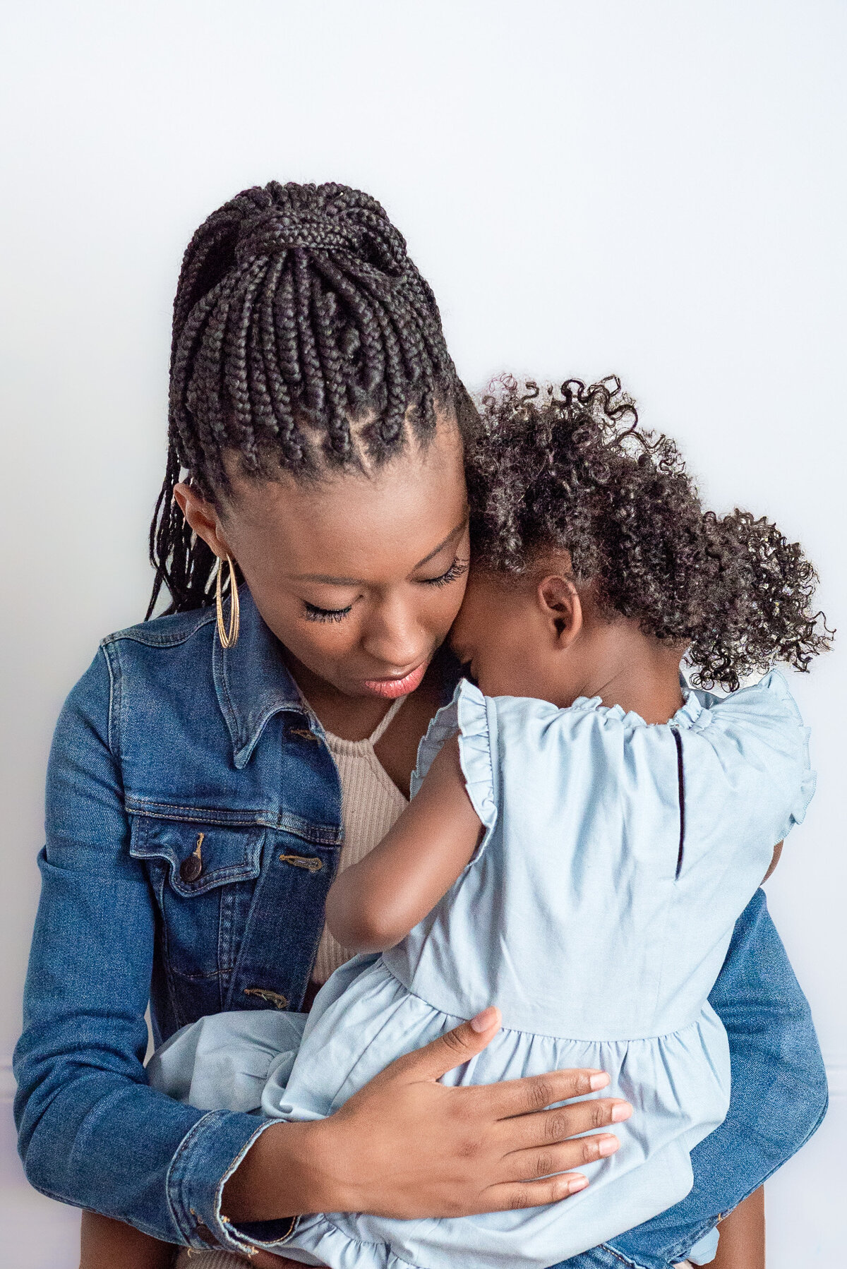 A mother embraces her young daughter during family pictures in Huntsville Alabama