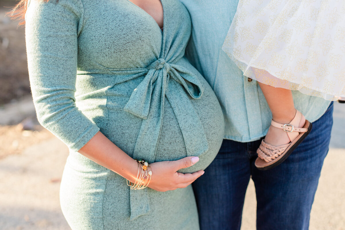 mom holds her baby belly