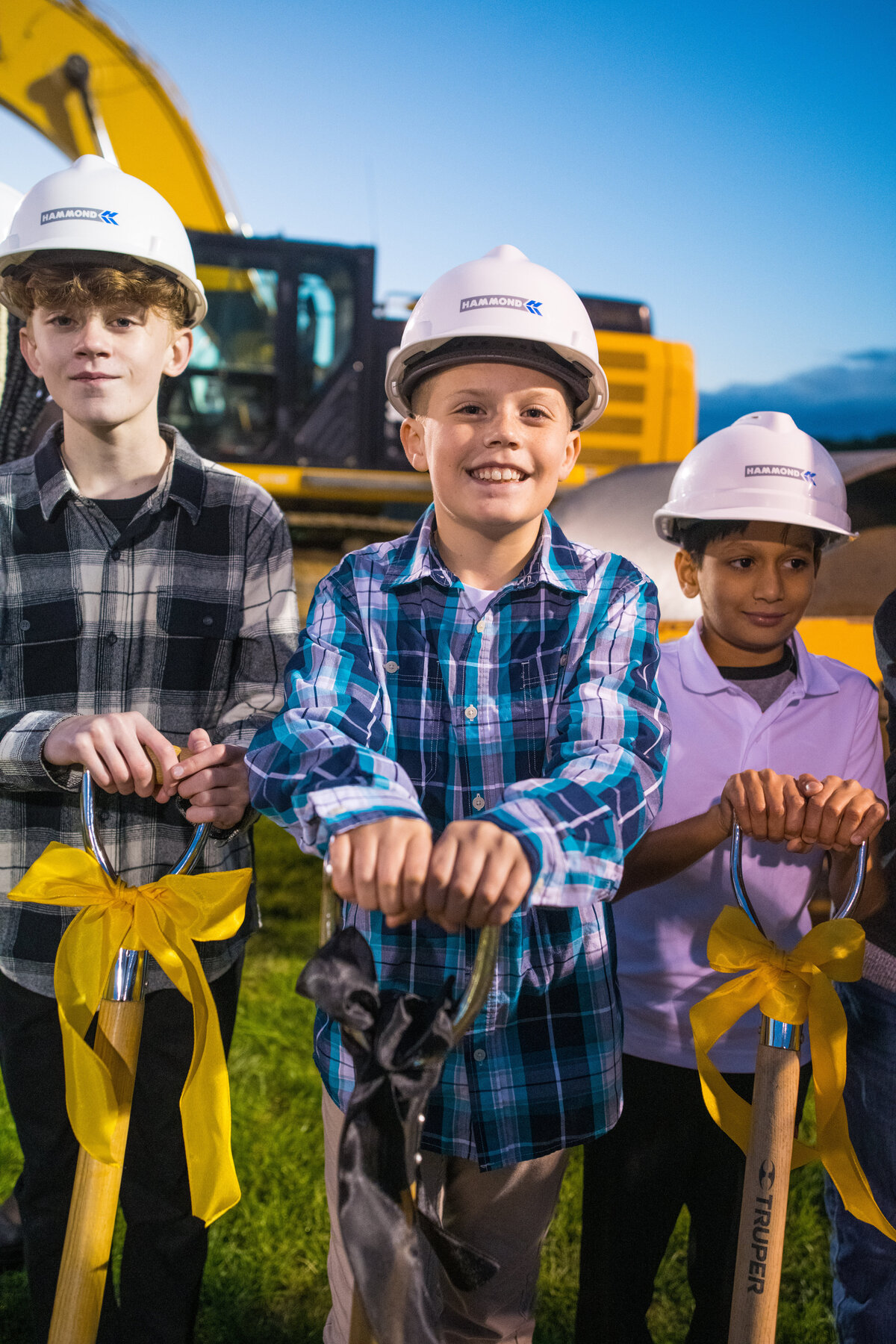 smiling boy hold shovel handle at groundbreaking ceremony cuyahoga falls school district