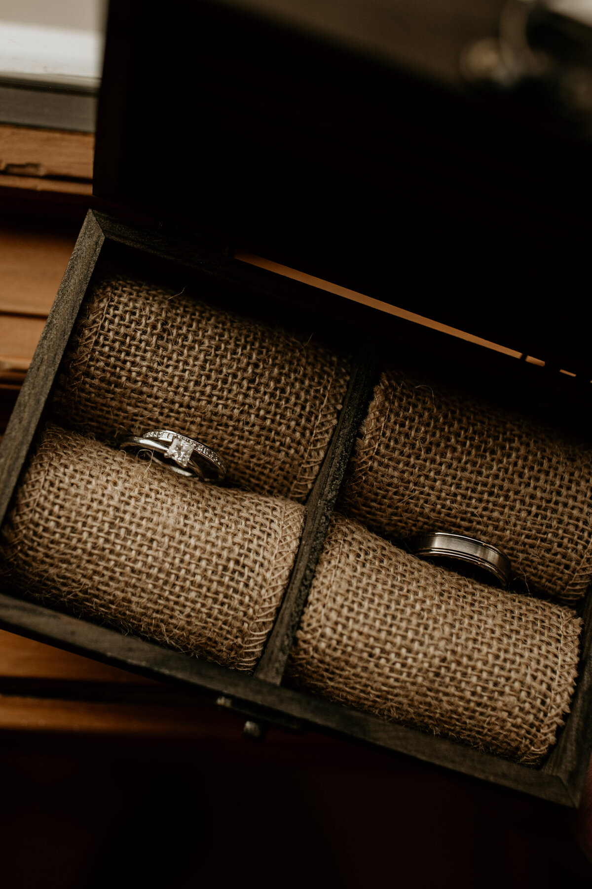 wedding rings sitting in a wooden box