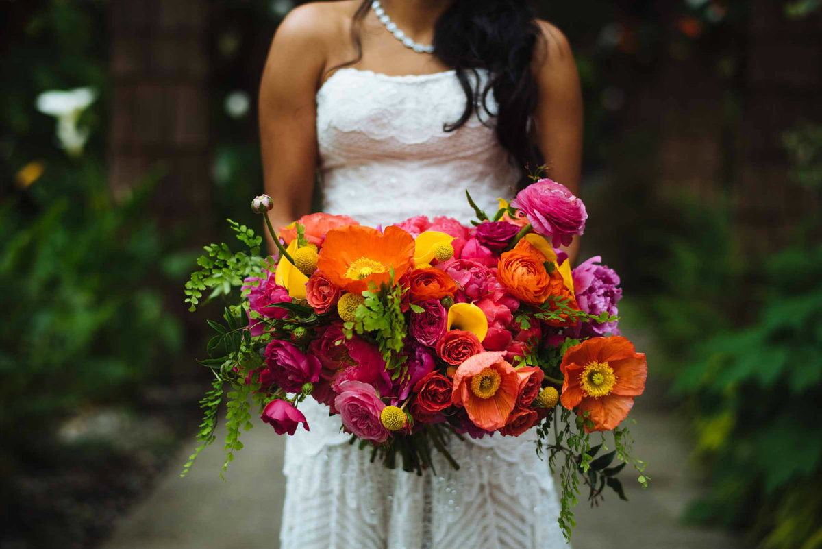 Coral charm peonies and orange poppies give this wedding bouquet designed by Flora Nova Design such happiness.