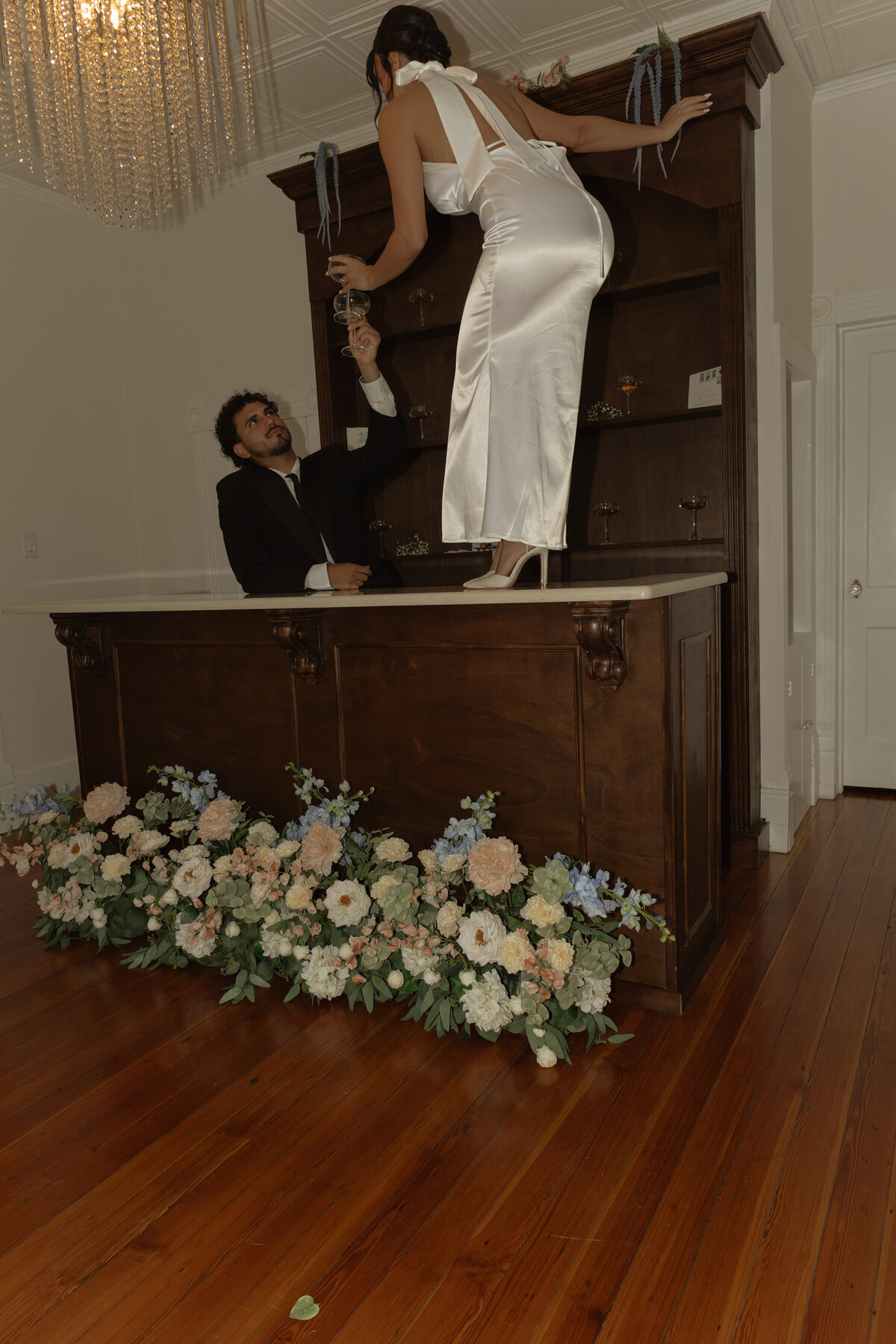 Champagne shelf display with gold accents at a luxury backyard wedding in Umatilla, Florida