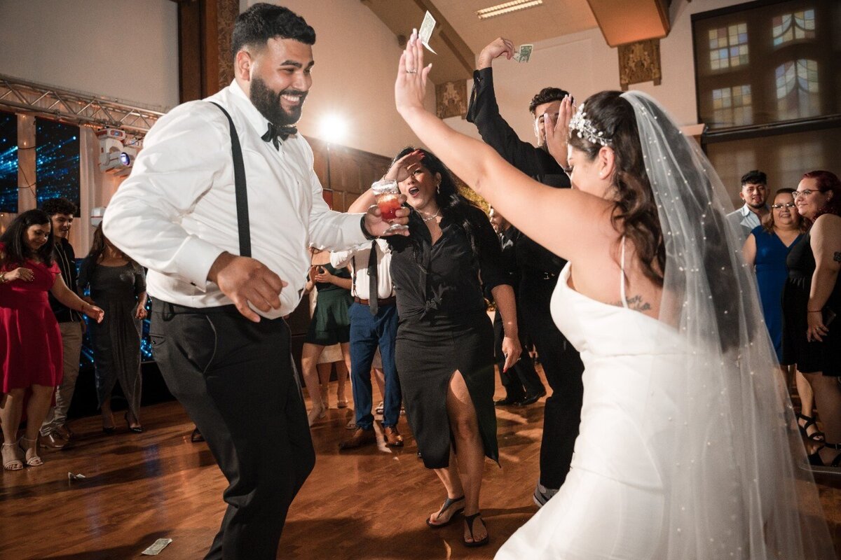 Bride and groom dancing with joy during the reception party at Union Club Hotel.