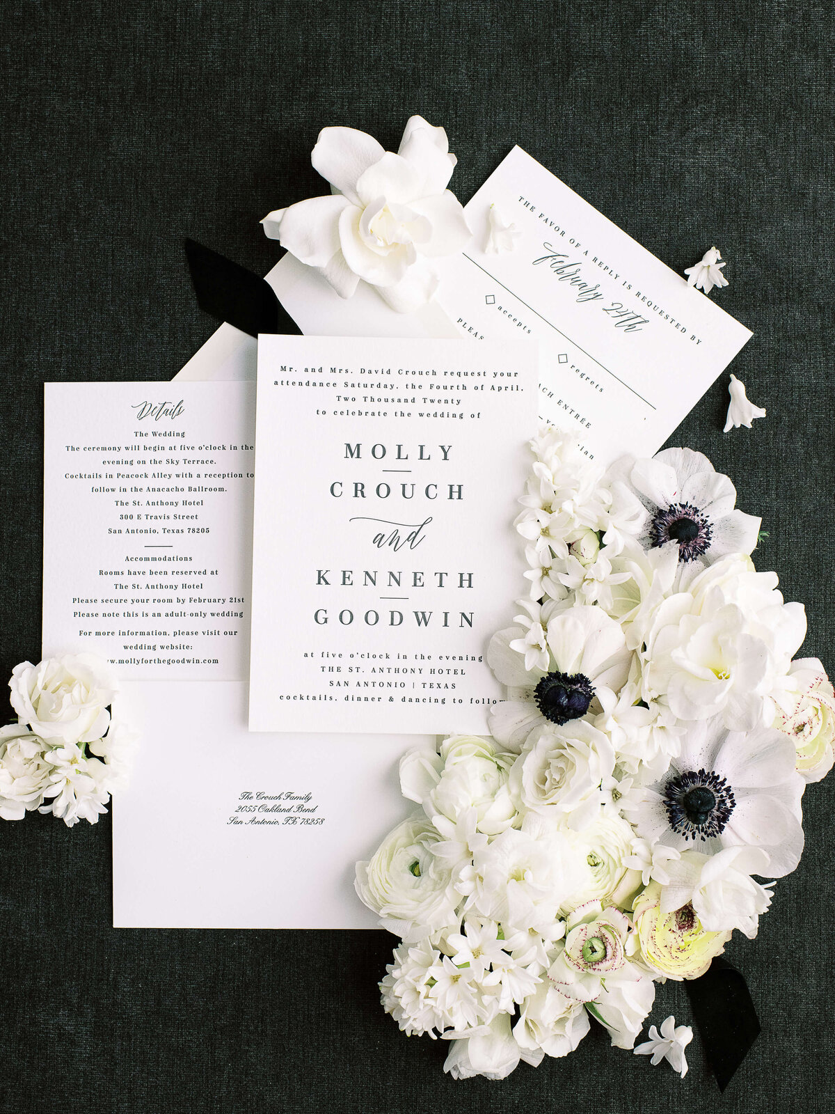 Elegant black and white San Antonio wedding invitation flatlay with florals