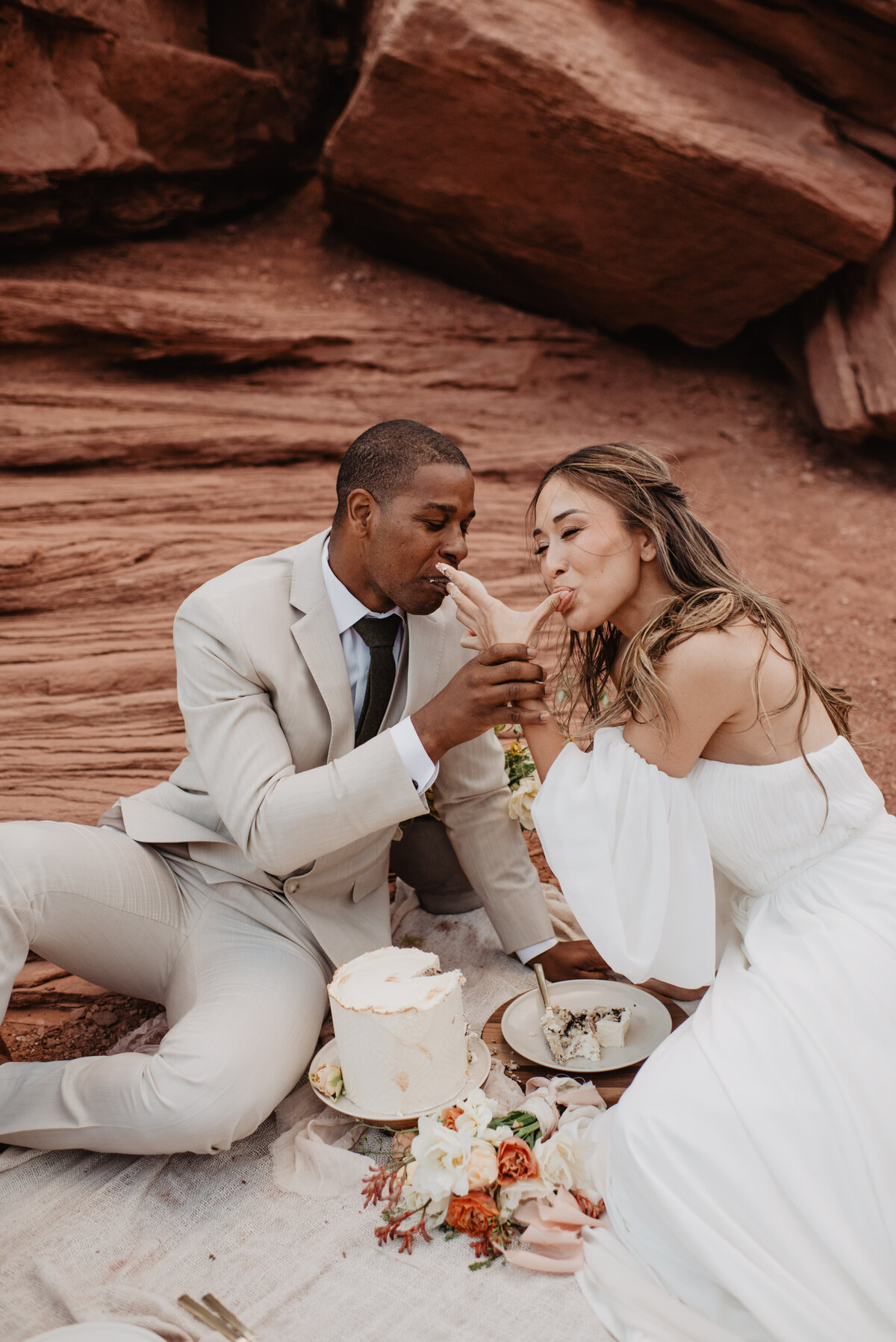 Utah Elopement Photographer captures bride and groom licking fingers