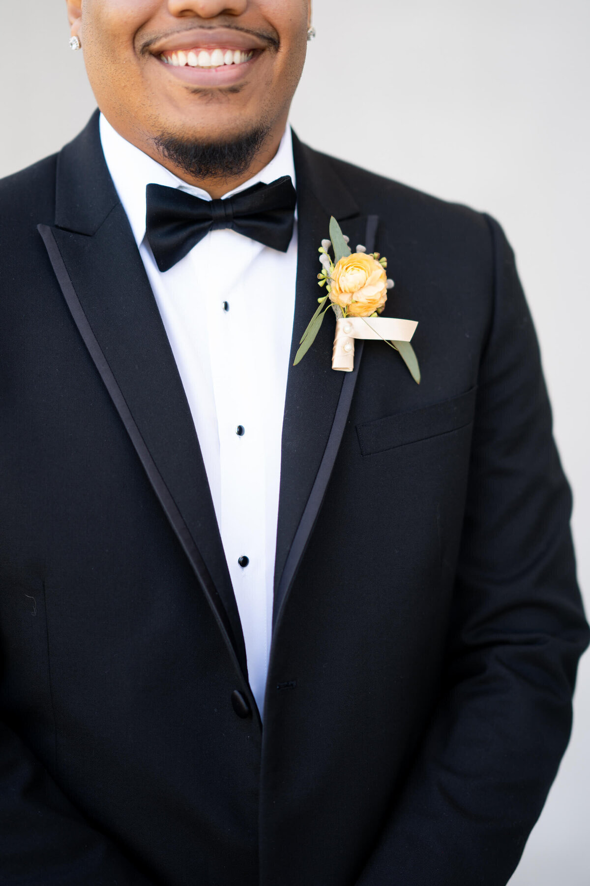 black-groom-chicago-tuxedo-ballroom-history museum-boutonniere-florals-bowtie-tuxedo