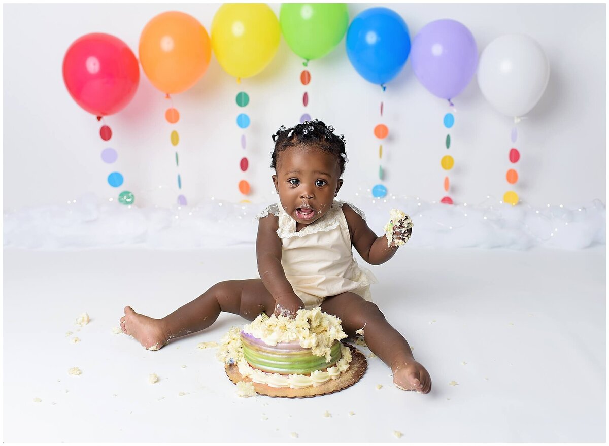 A little one's cake smash session, capturing their delight as they dive into a cake with abandon.