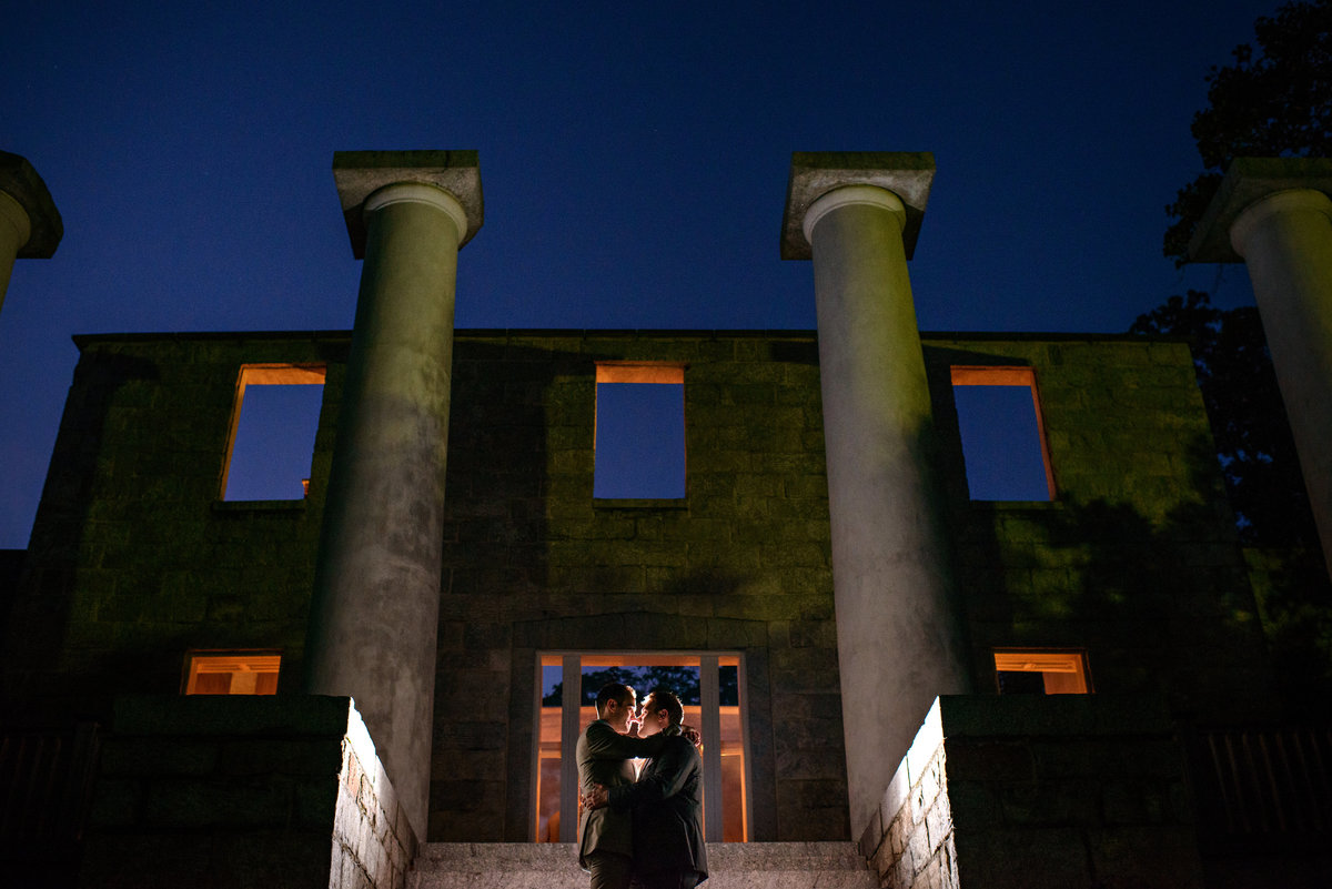 A same sex wedding couple hug in front of the ruins of the Patapsco Female Institute.