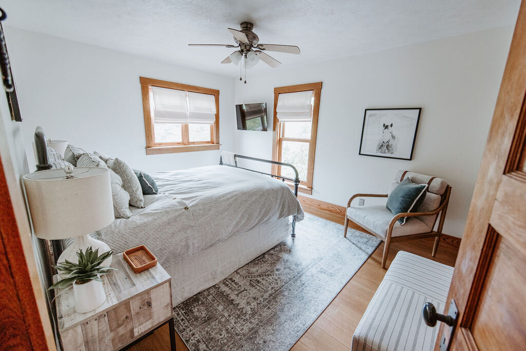 the slate blue and gray primary bedroom in the modern farmhouse overnight accommodations at Willowbrook wedding venue