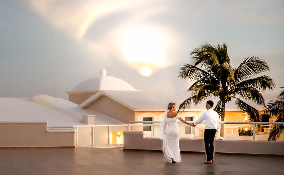 Wedding in Cancun with couple walking towards sunset