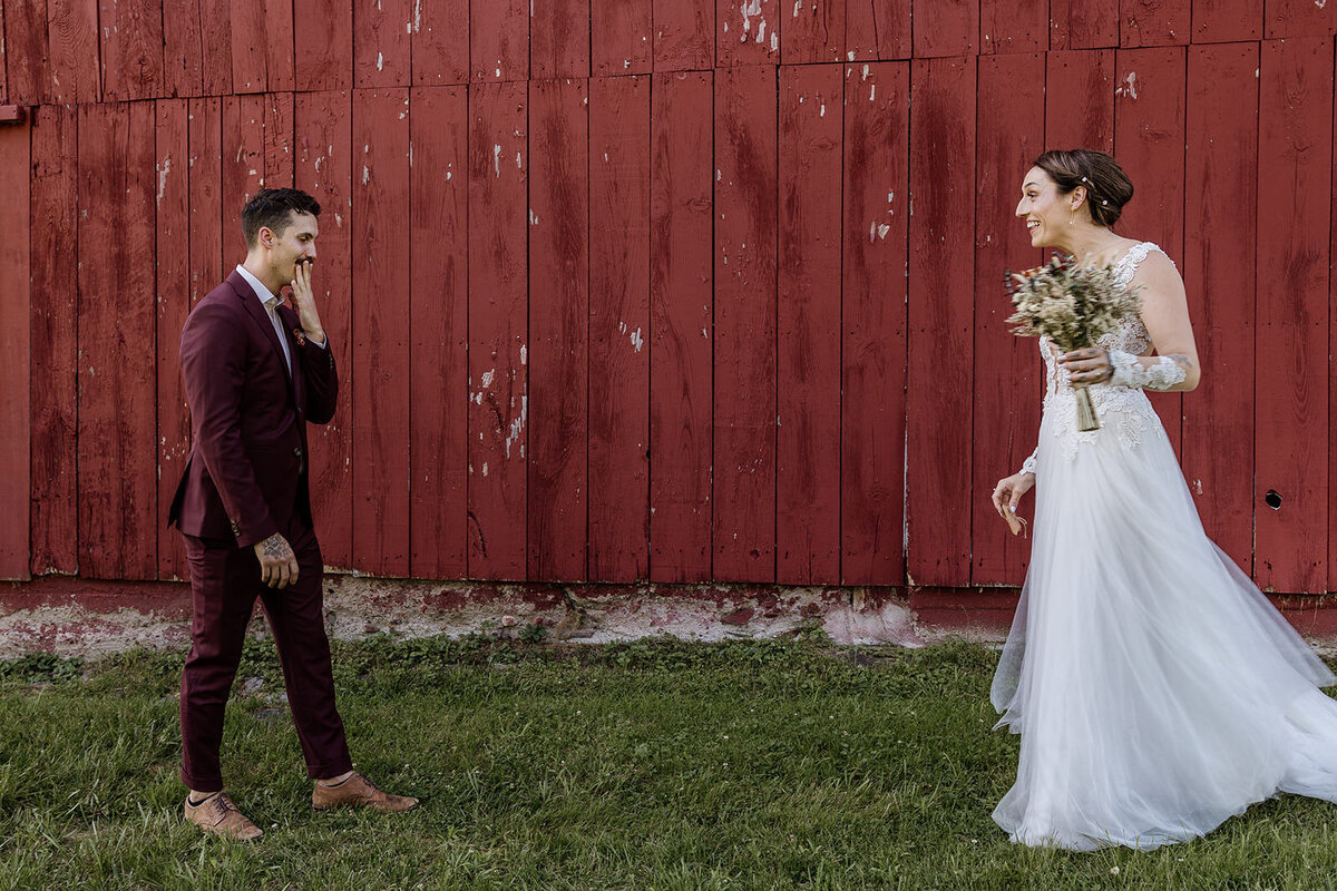 A couple smiling at each other during their first look