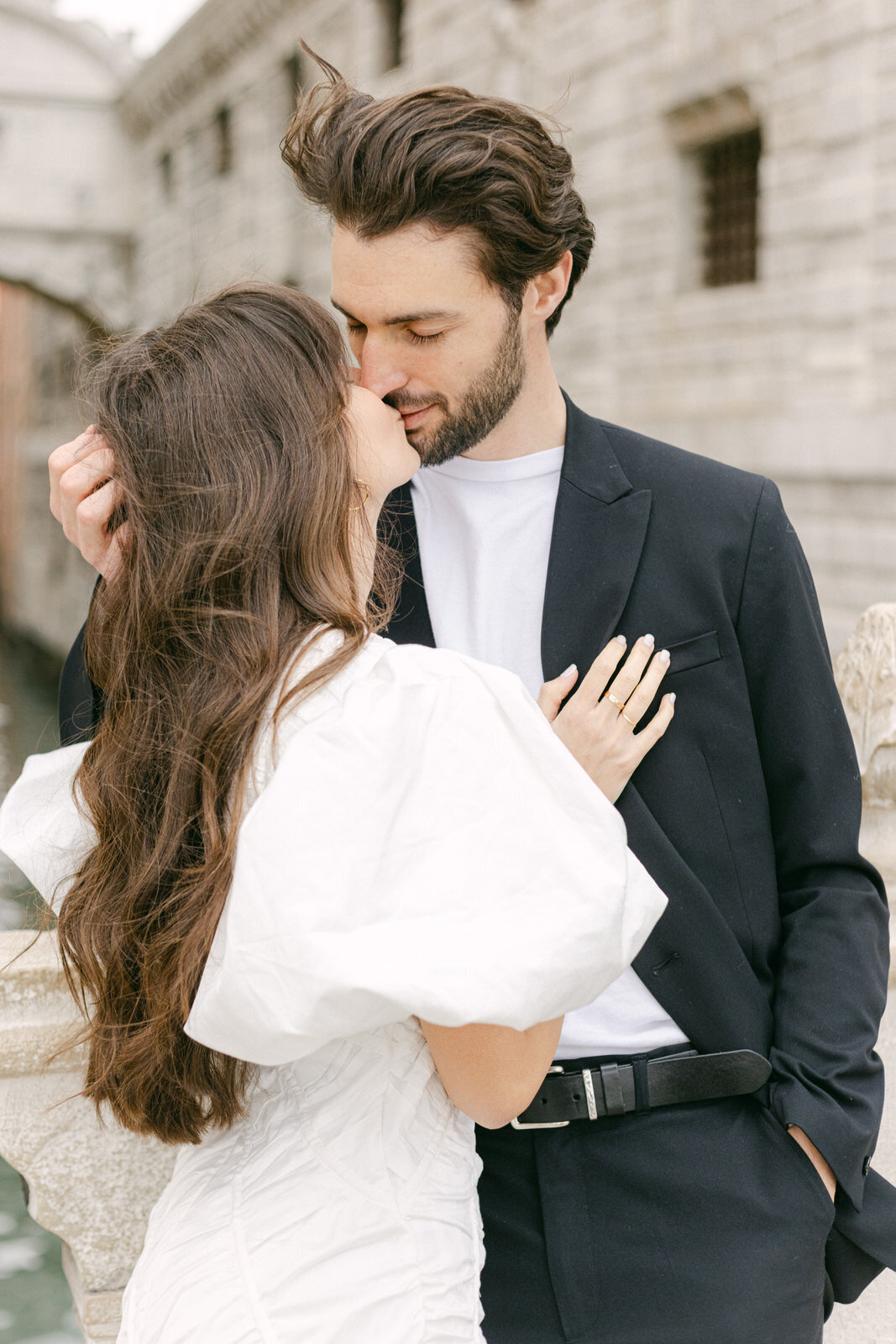 engaged couple's kiss