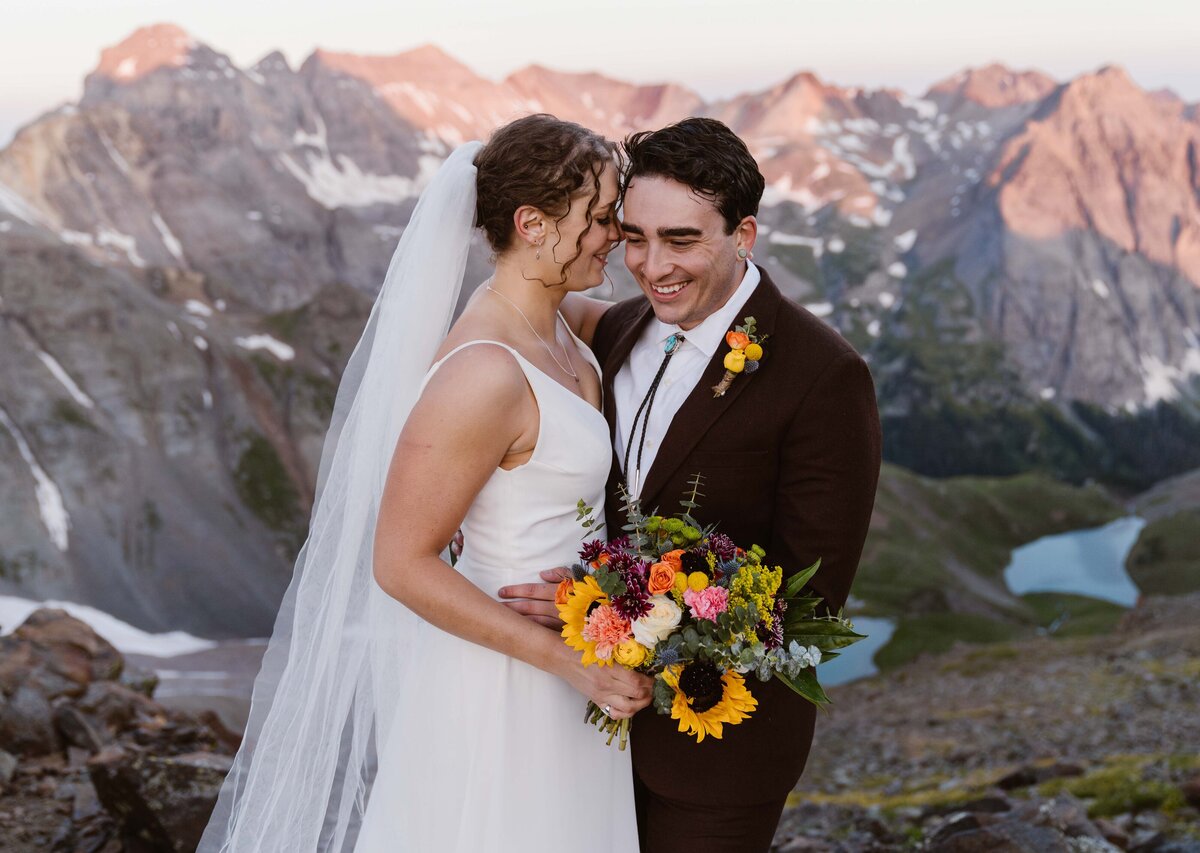Bride and groom celebrate their wedding surrounded by stunning Telluride mountain views