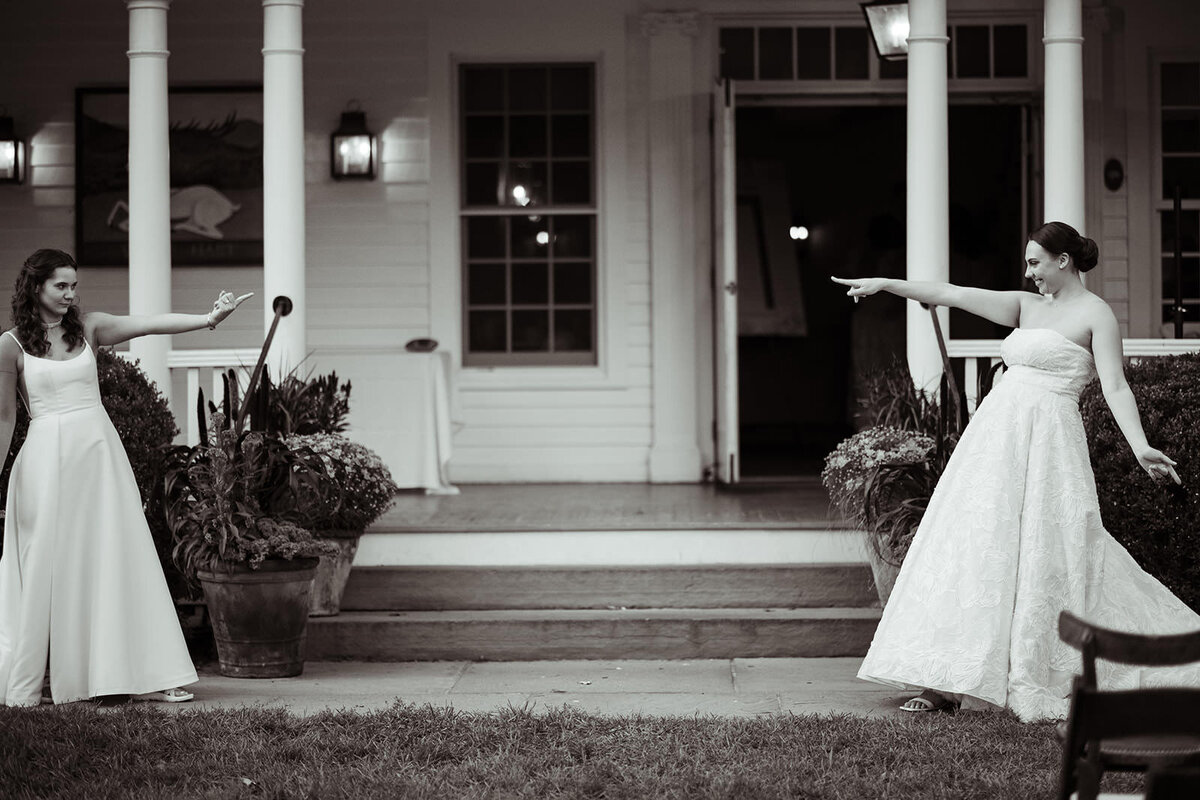 Two brides pointing at each other from either end