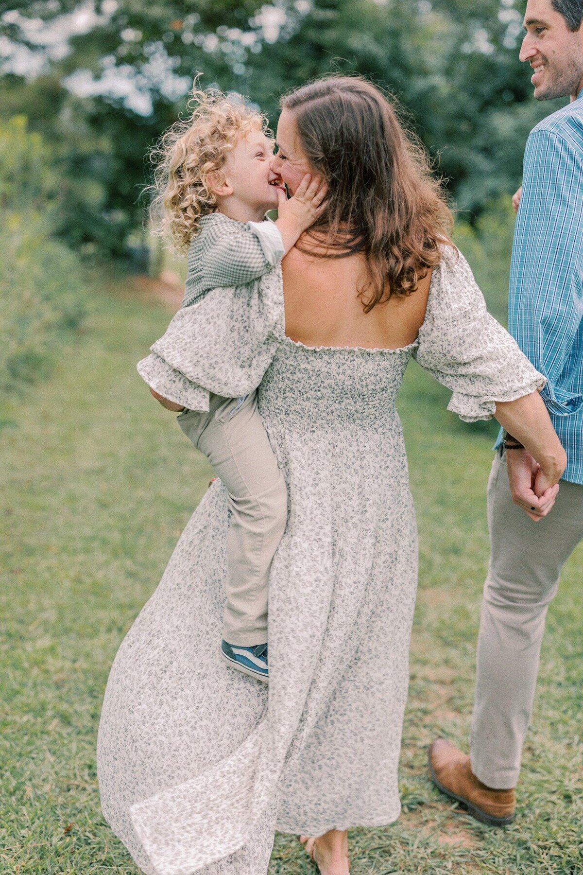boy-holding-moms-face-giving-her-kiss