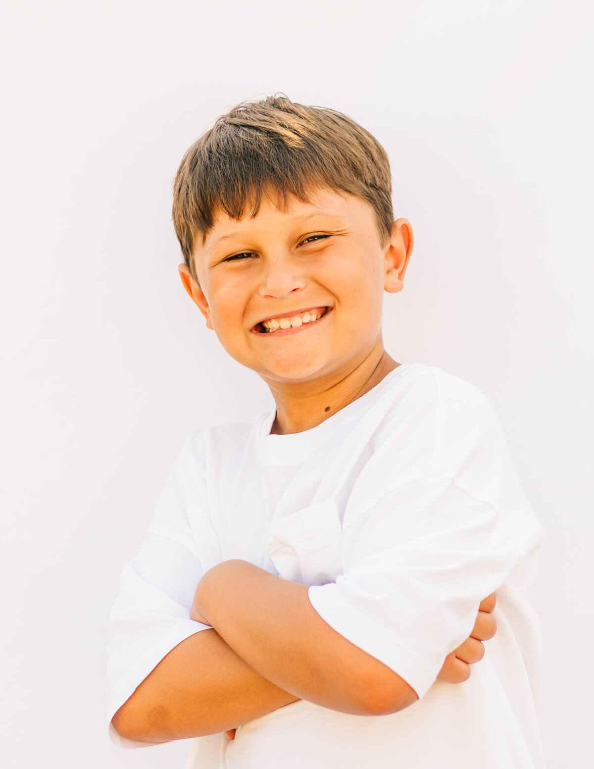 Portrait of 5th-grade boy with relaxed expression and bright background
