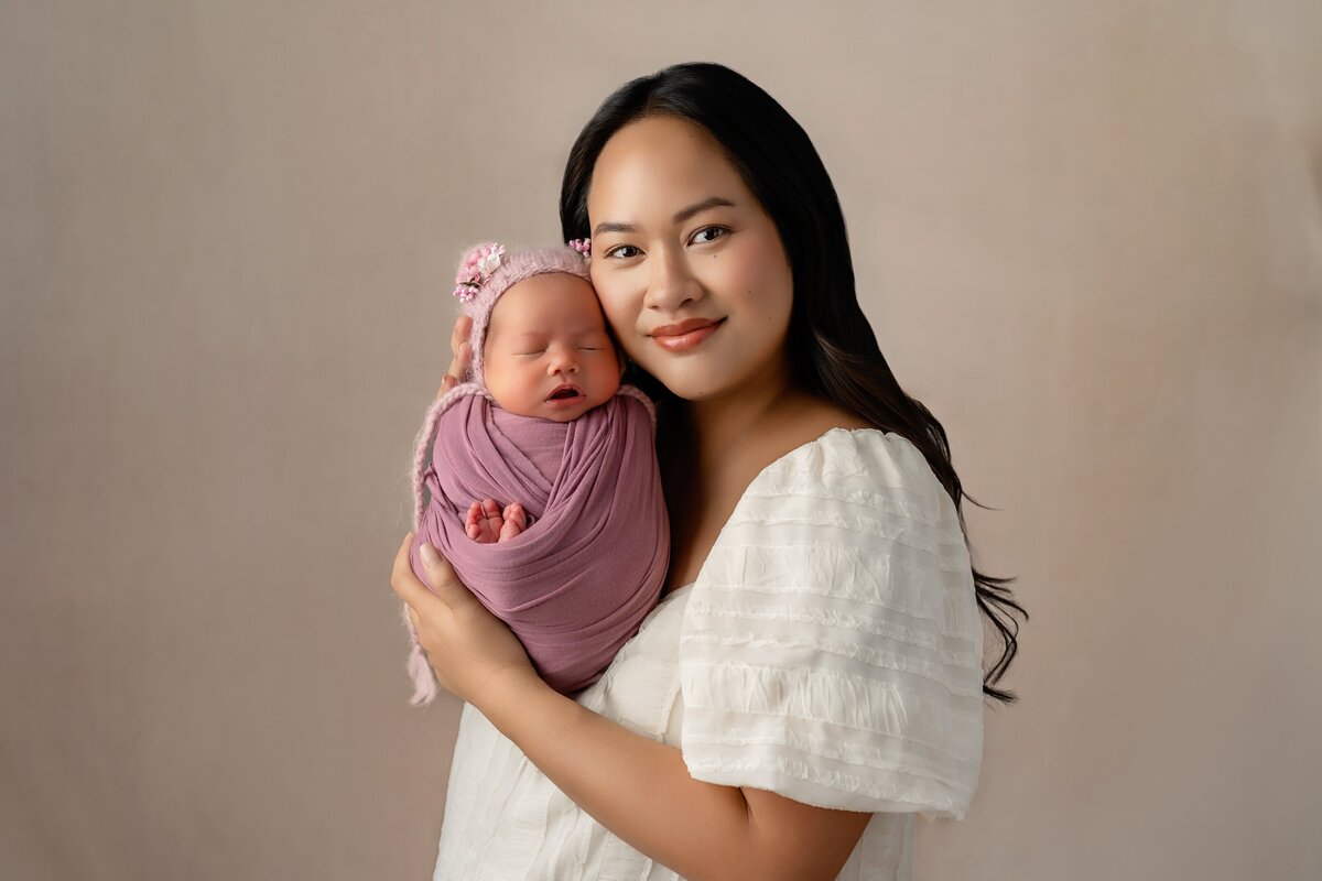 mom and daughter newborn photos in studio