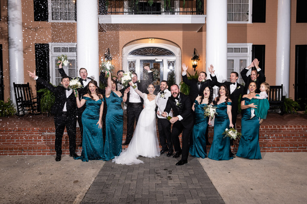 Fun wedding party shot at Southern Oaks, spraying champagne in celebration