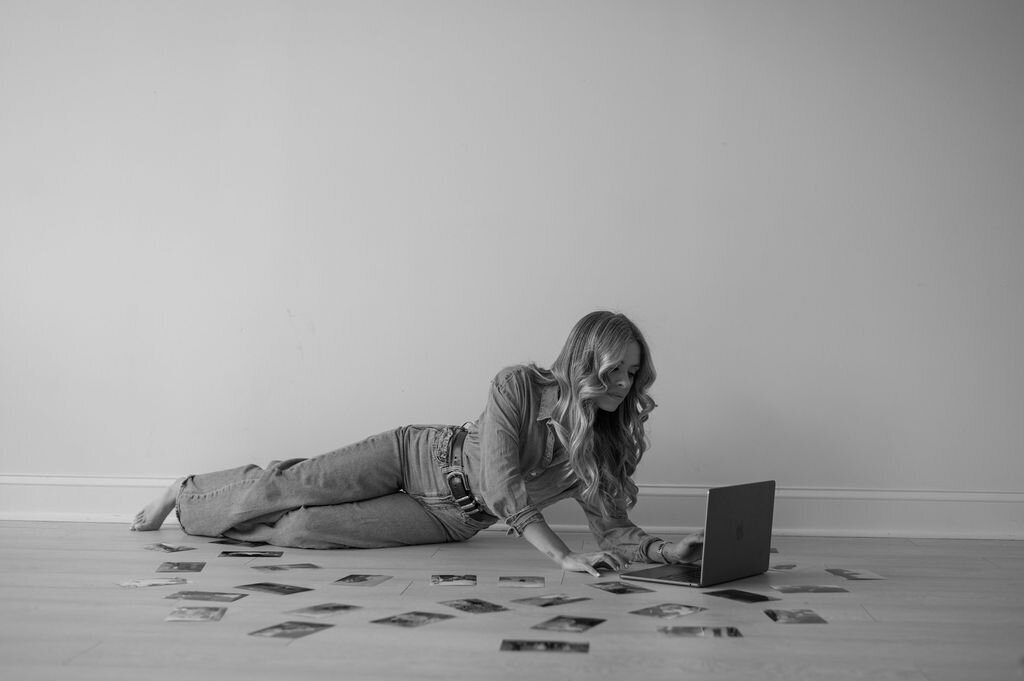 A photo of Michaela Crawford Photography's profile. She is shooting a photo with her camera.