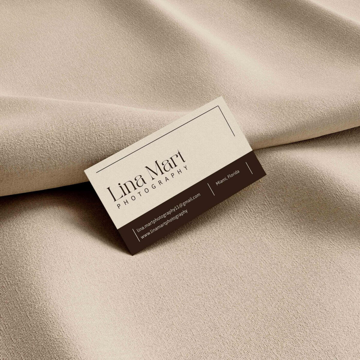 Luxury business card for Ruaa Hamdan Photography displayed on textured beige fabric