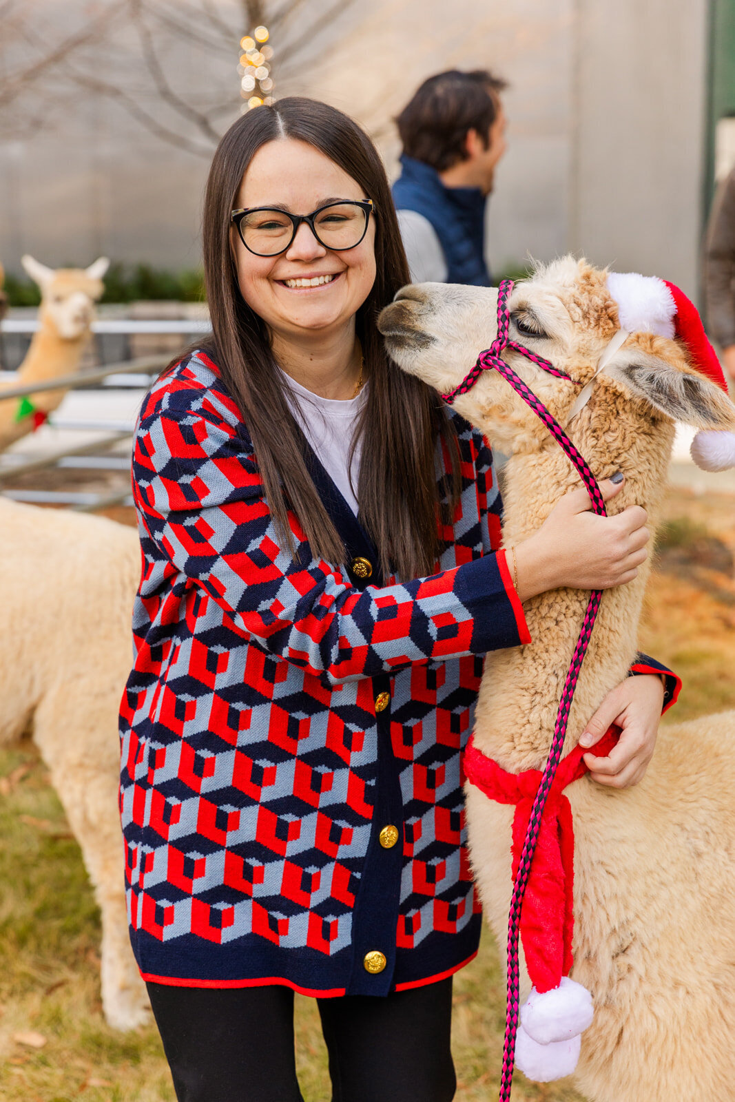 AFC woman employee posing with a lama during building management holiday party event photographer Laure Photography
