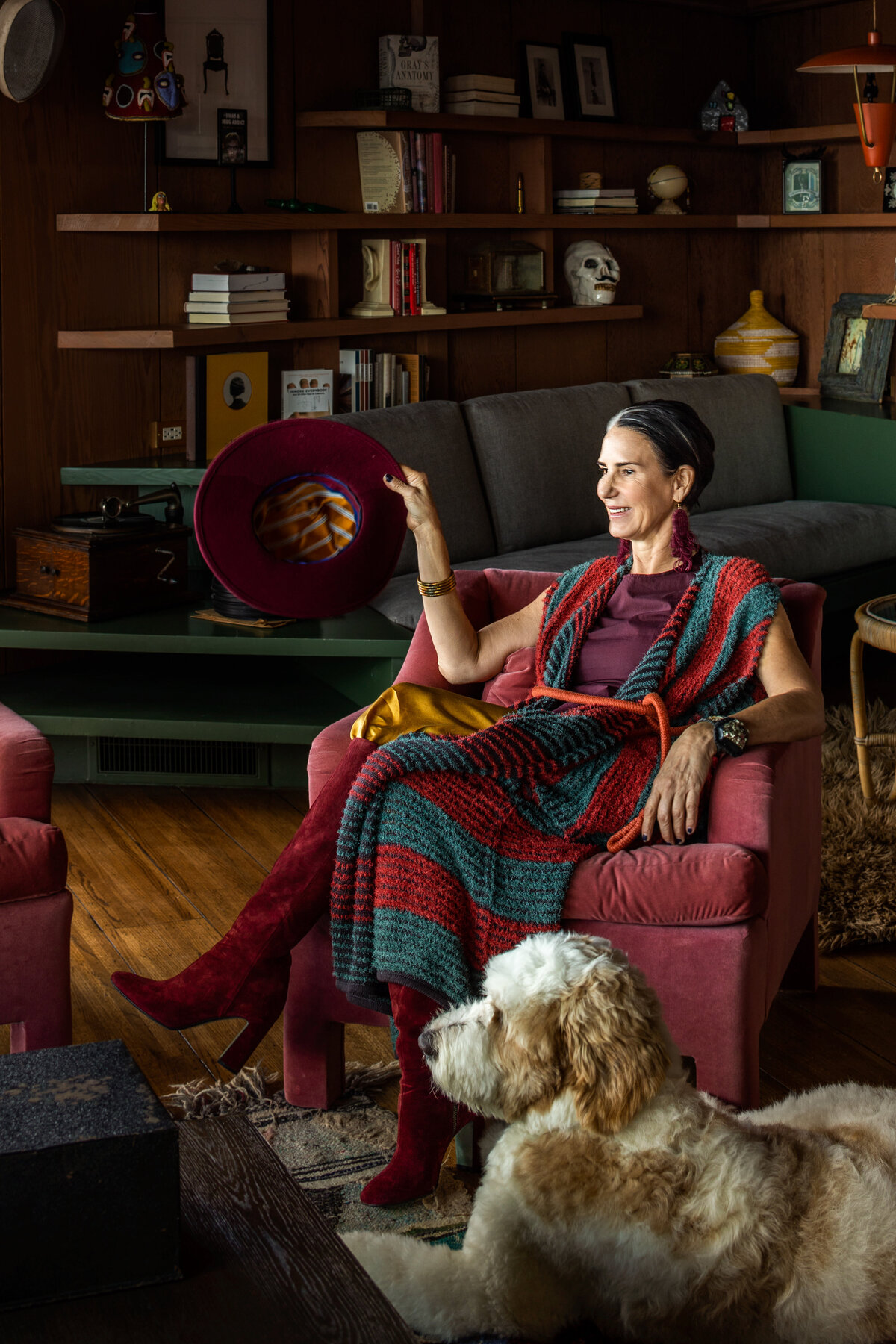 Interior photography featuring a stylish woman in a vibrant living room with a pet dog