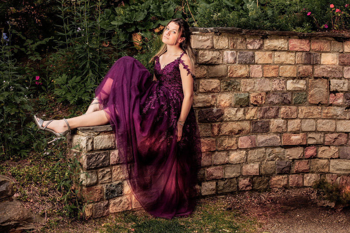 Calgary Highschool Graduate posing at Reader Rock Garden in grad dress