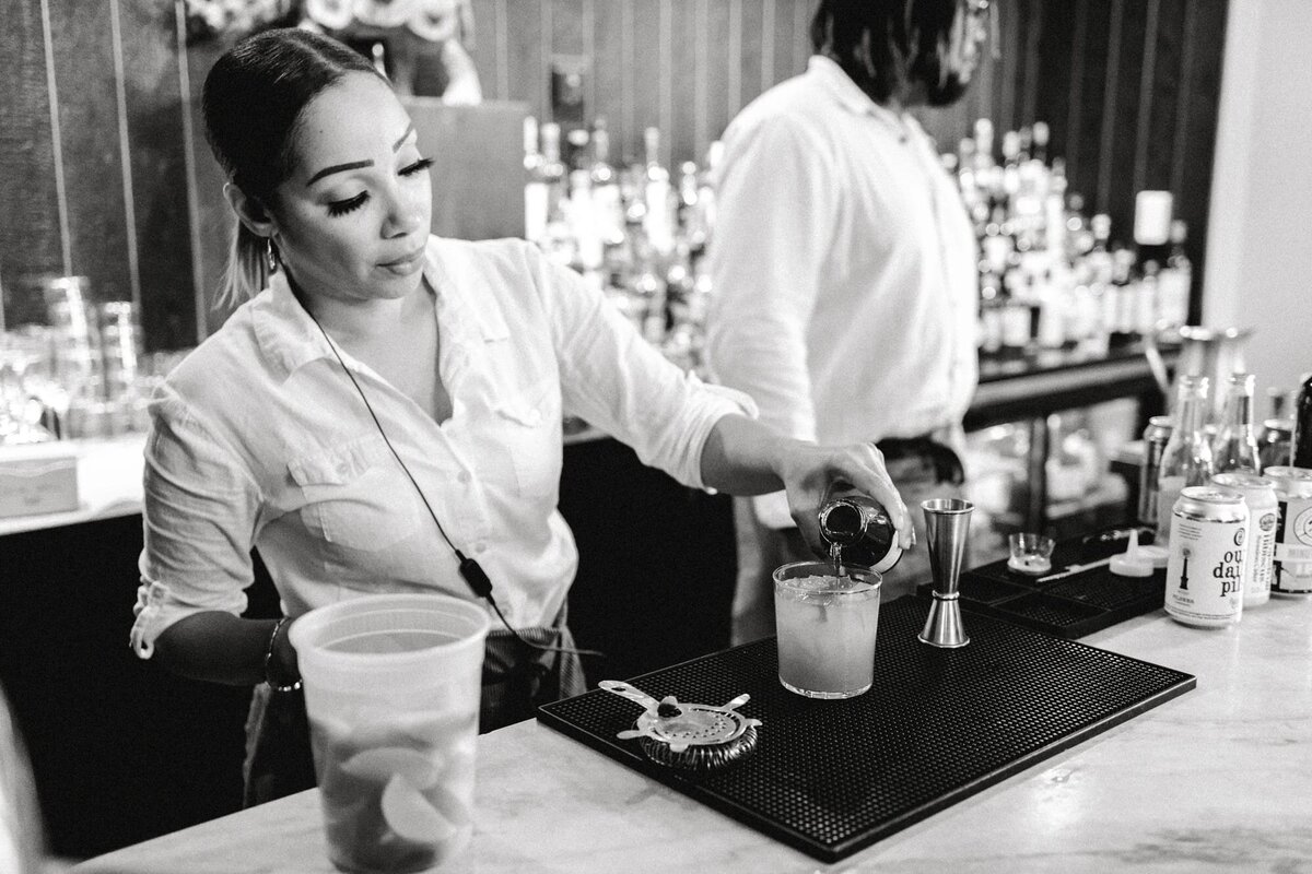 Bartender pours drink at Common House Charlottesville wedding