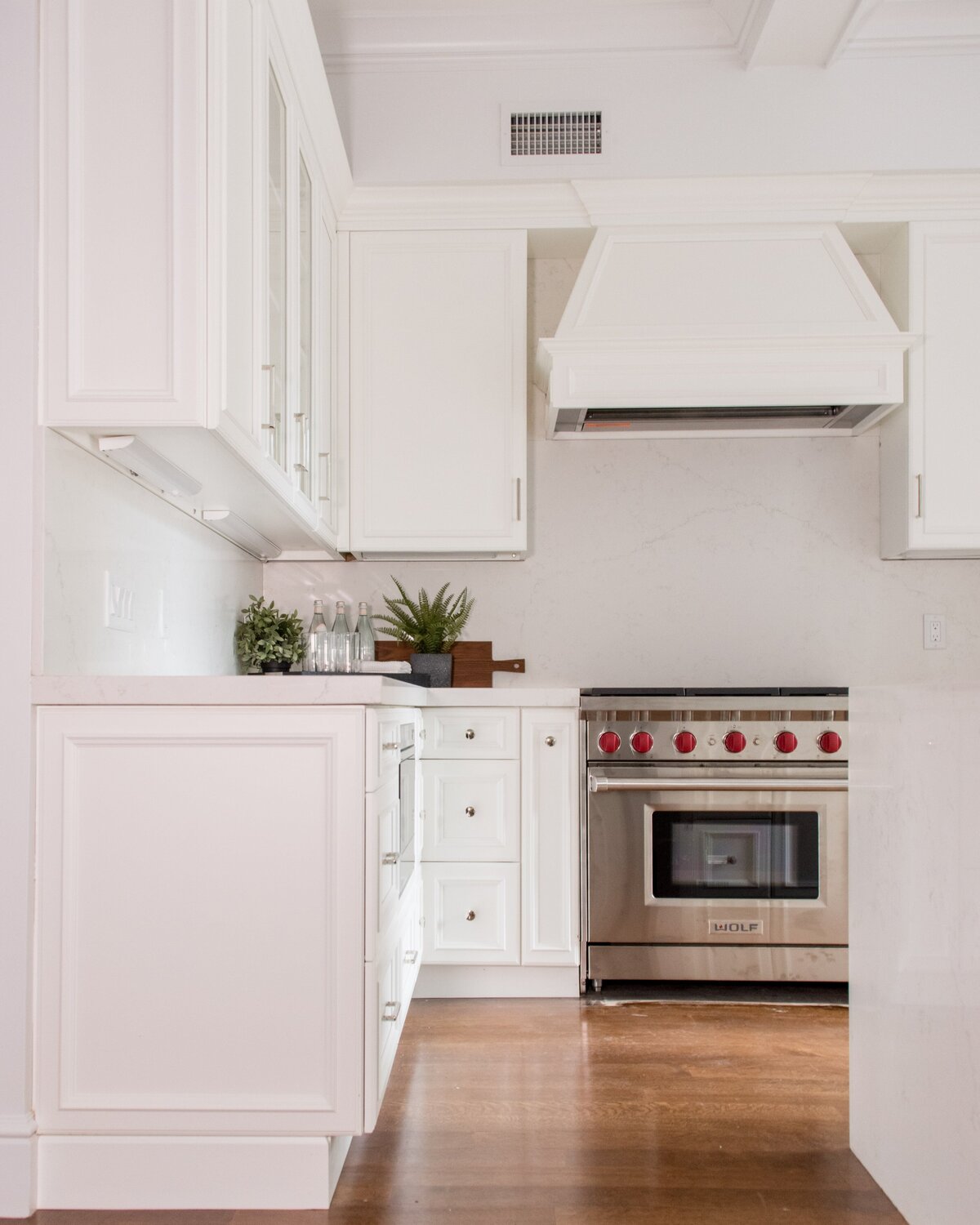 white-kitchen-wolf-range-custom-hood-paneled-cabinets-comm-ave-min