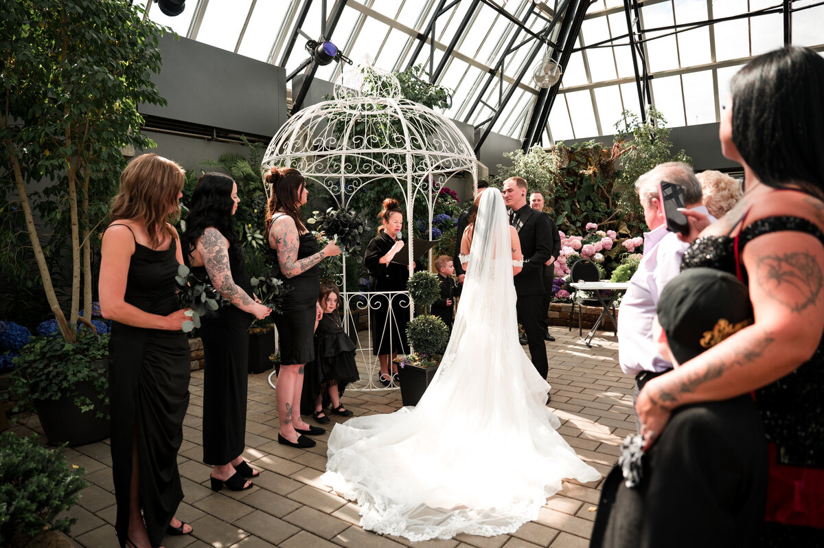 greenhouse wedding ceremony, bride and groom surrounded by plants and trees