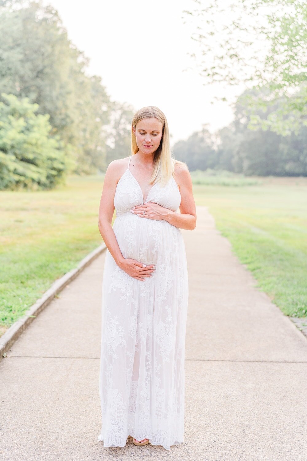 mom looking down at belly taken by an Ashburn, Virginia maternity photographer