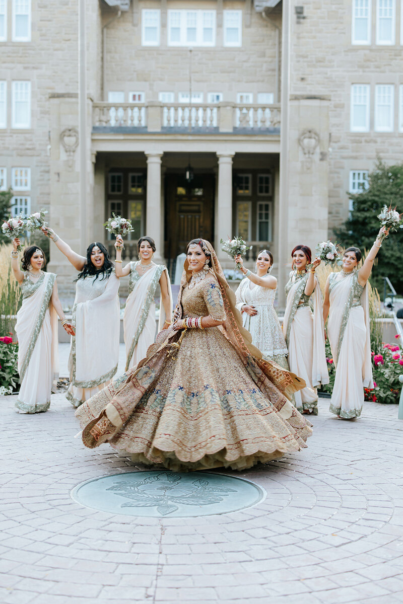 Traditional gold Indian wedding dress with her bridesmaides.