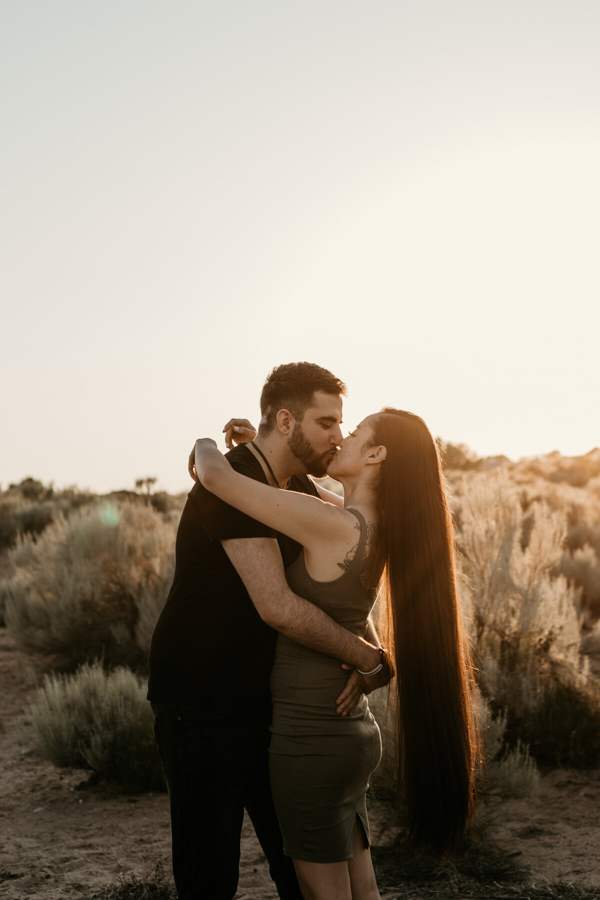 long haired woman kissing fiancé