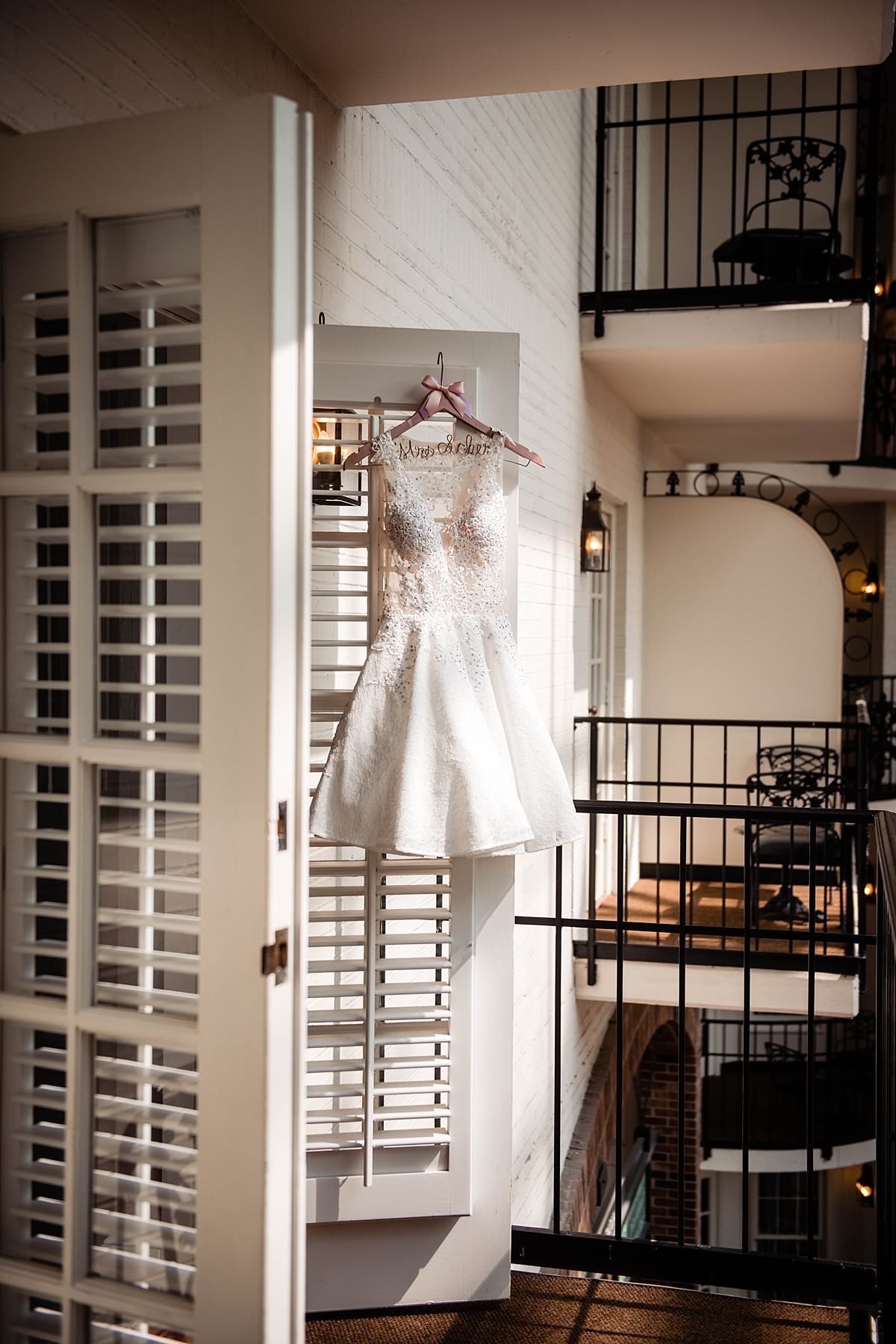 Reception dress hanging from doors on balcony