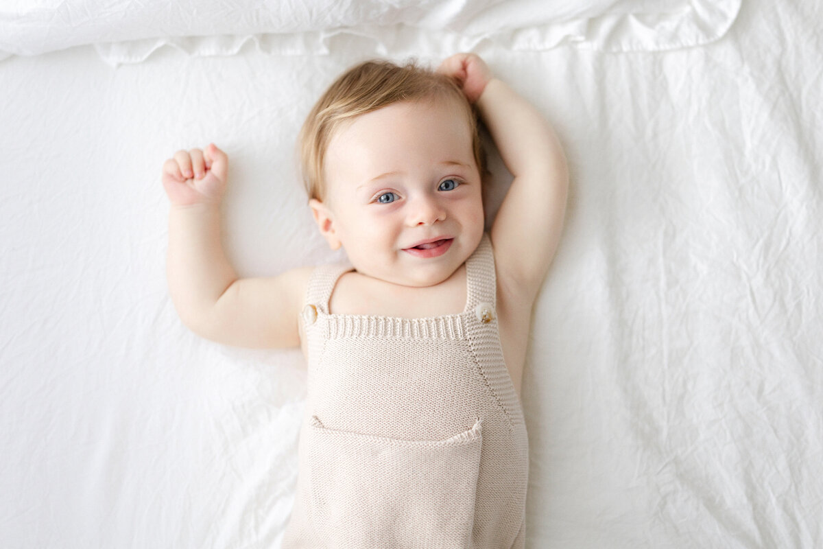 Tampa 6-month milestone portrait of smiling baby boy in natural light studio