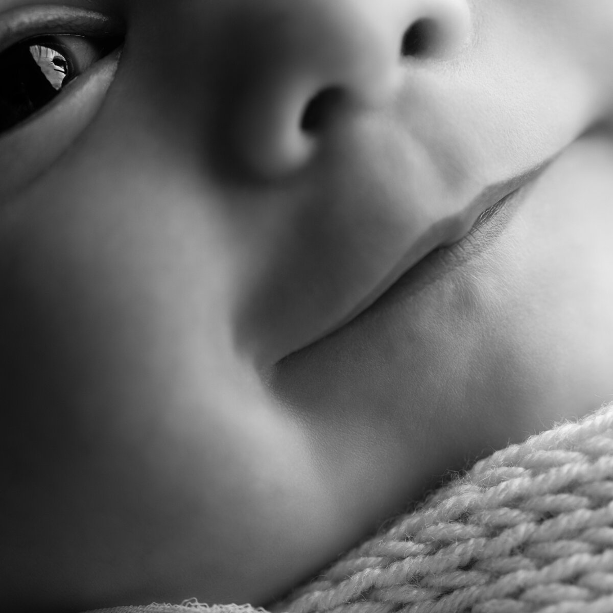 A beautifully layered macro portrait capturing newborn awareness—one glance, a thousand feelings.