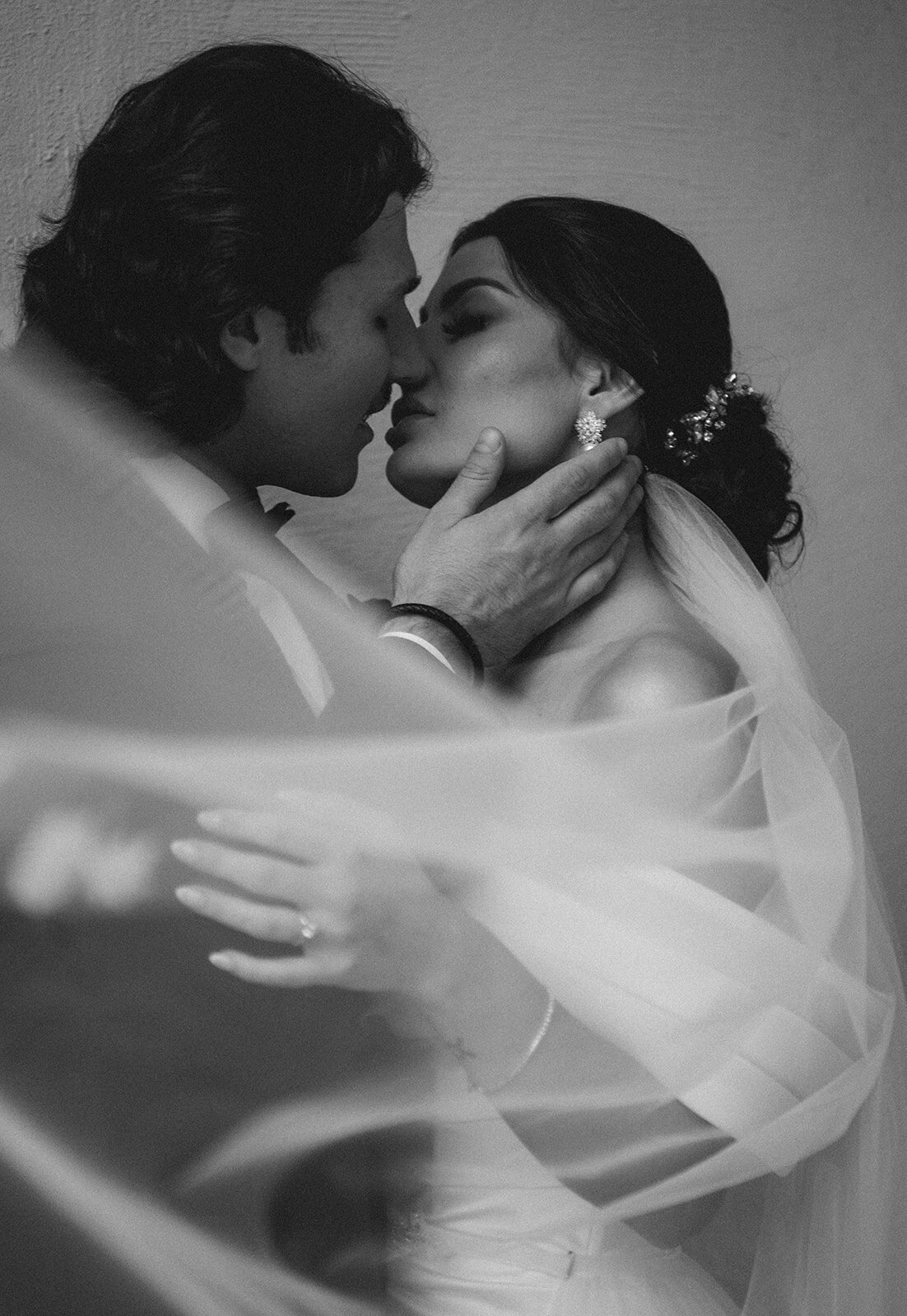 bride and groom share moment right before a kiss with veil draping in foreground at their wadsworth mansion wedding photo by cait fletcher photography