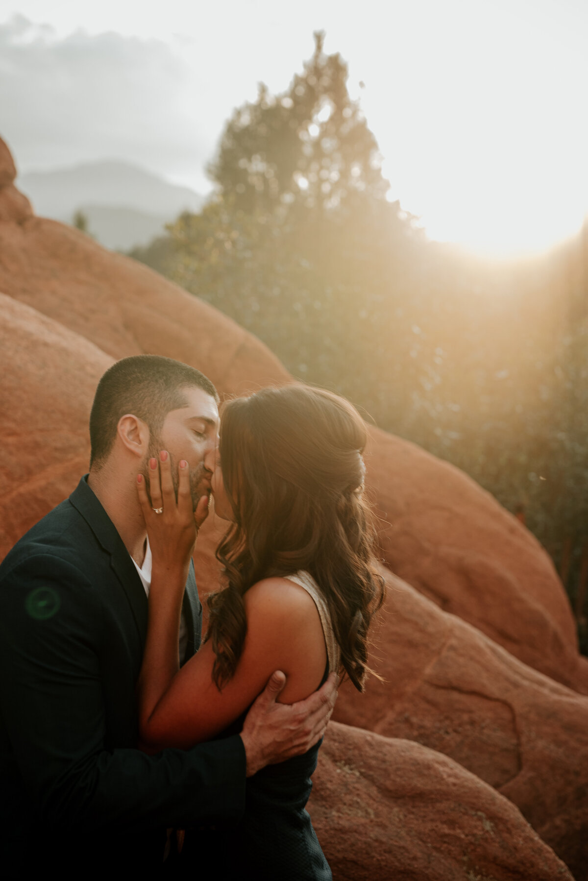 couple kissing on engagement shoot at red rocks