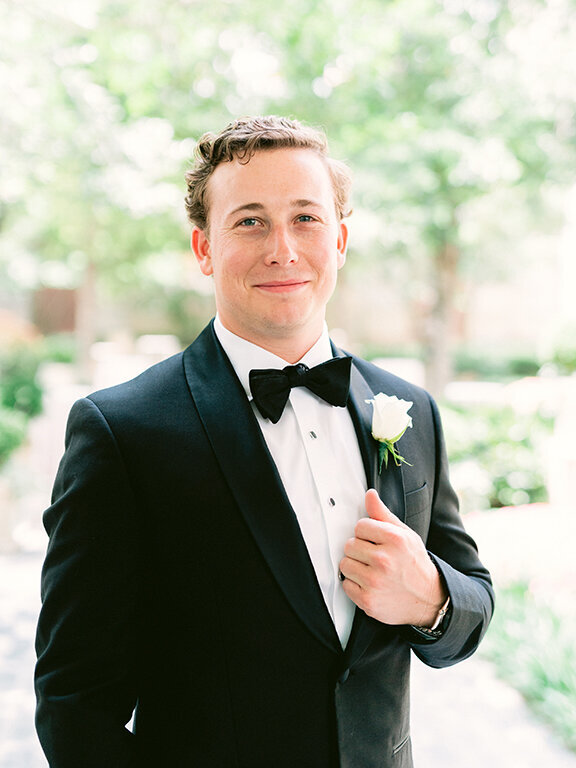 Groom wearing black suit and bowtie at wedding at  Hotel Crescent Court, Dallas